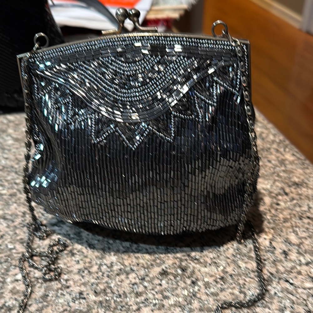 Silver Clutch with Intricate Beaded Design and Chain Strap
